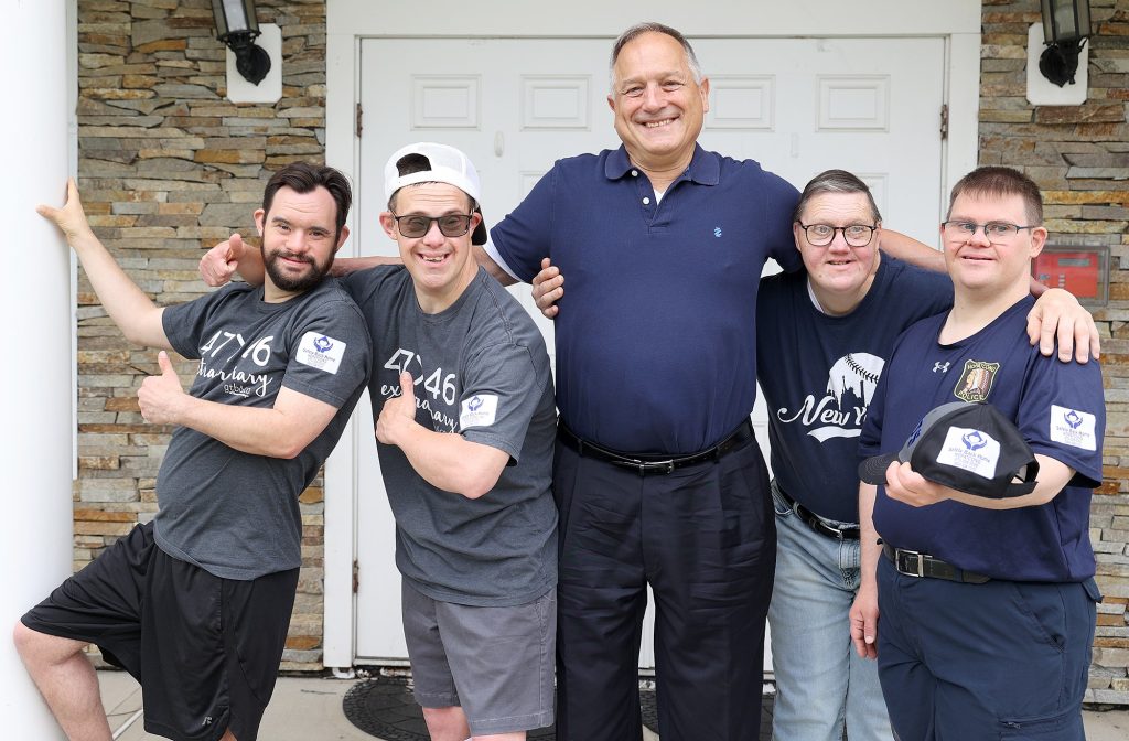 Paul Jetter poses with residents at the Hopatcong SMILE Home.